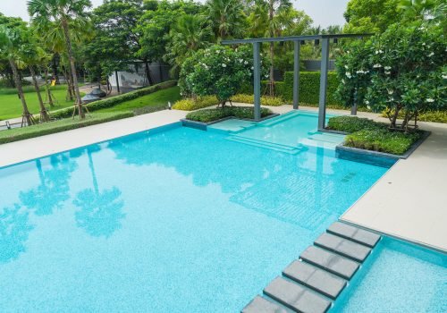 Beautiful luxury swimming pool with palm tree - Boost up color Processing
