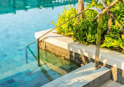 Outdoor swimming pool with stair ladder around there for leisure vacation travel concept
